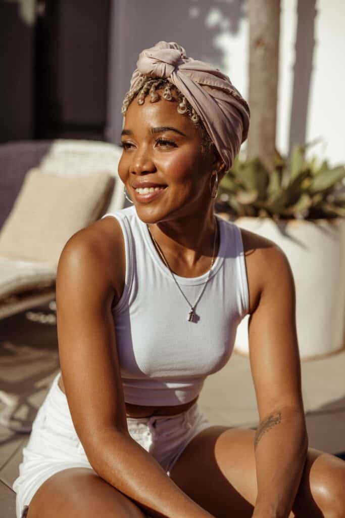 a woman wearing a white shirt and a turban