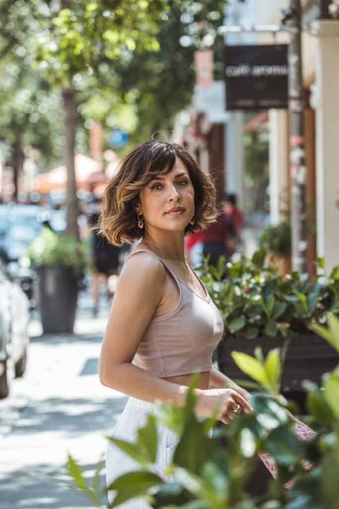 a woman standing on a sidewalk