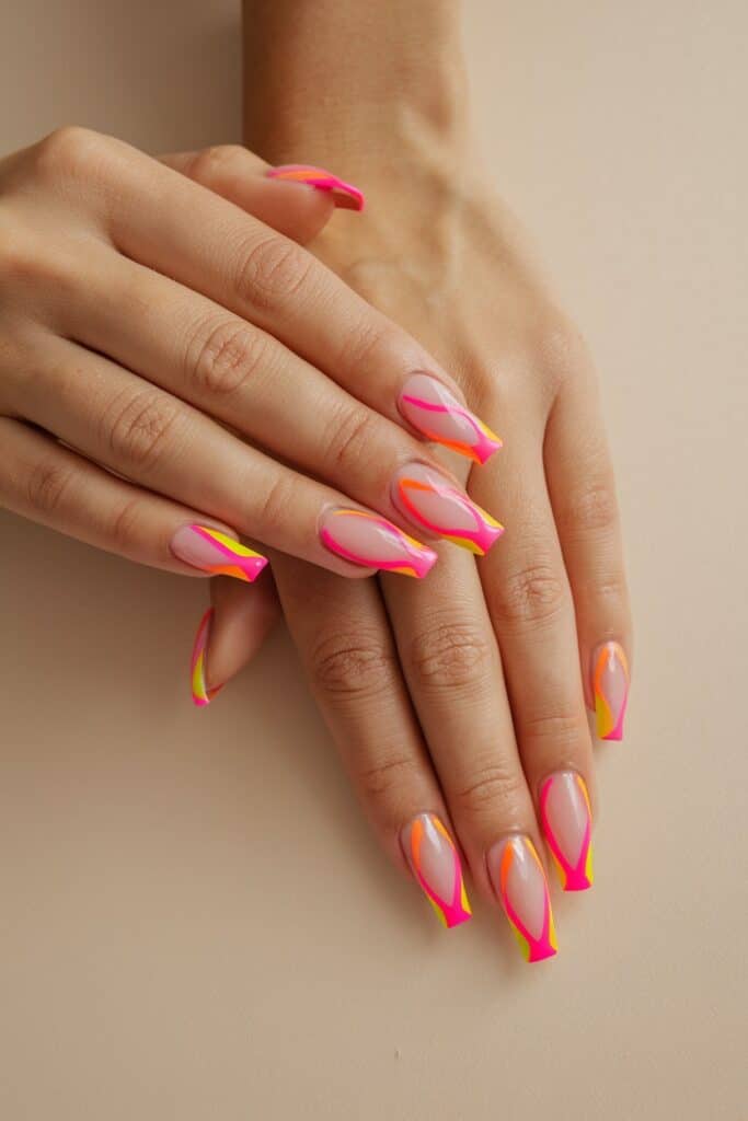 Hot pink and neon orange swirl French tips on nude acrylic nails, styled with a bold, modern twist.