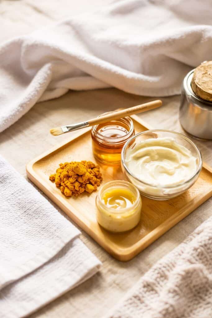 Woman with glowing skin after using a turmeric face mask as part of her regular skincare routine.