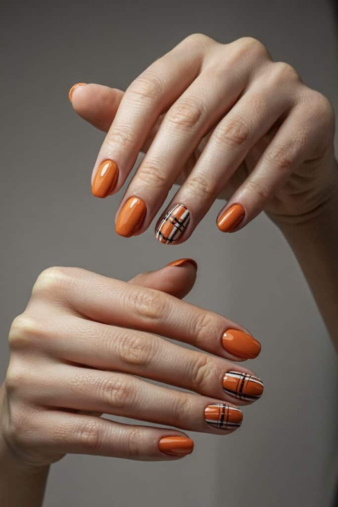 11. **Burnt Orange with Plaid Accent**: Burnt orange nails with a cozy plaid accent nail in autumn colors.
