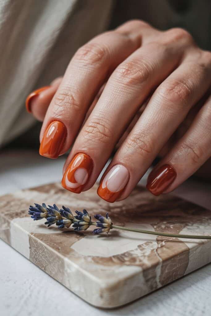 16. **Burnt Orange Negative Space**: Minimalist burnt orange nails with geometric negative space designs.
