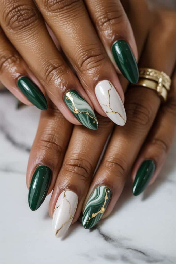 Marble green nails with fine gold veining on short oval tips