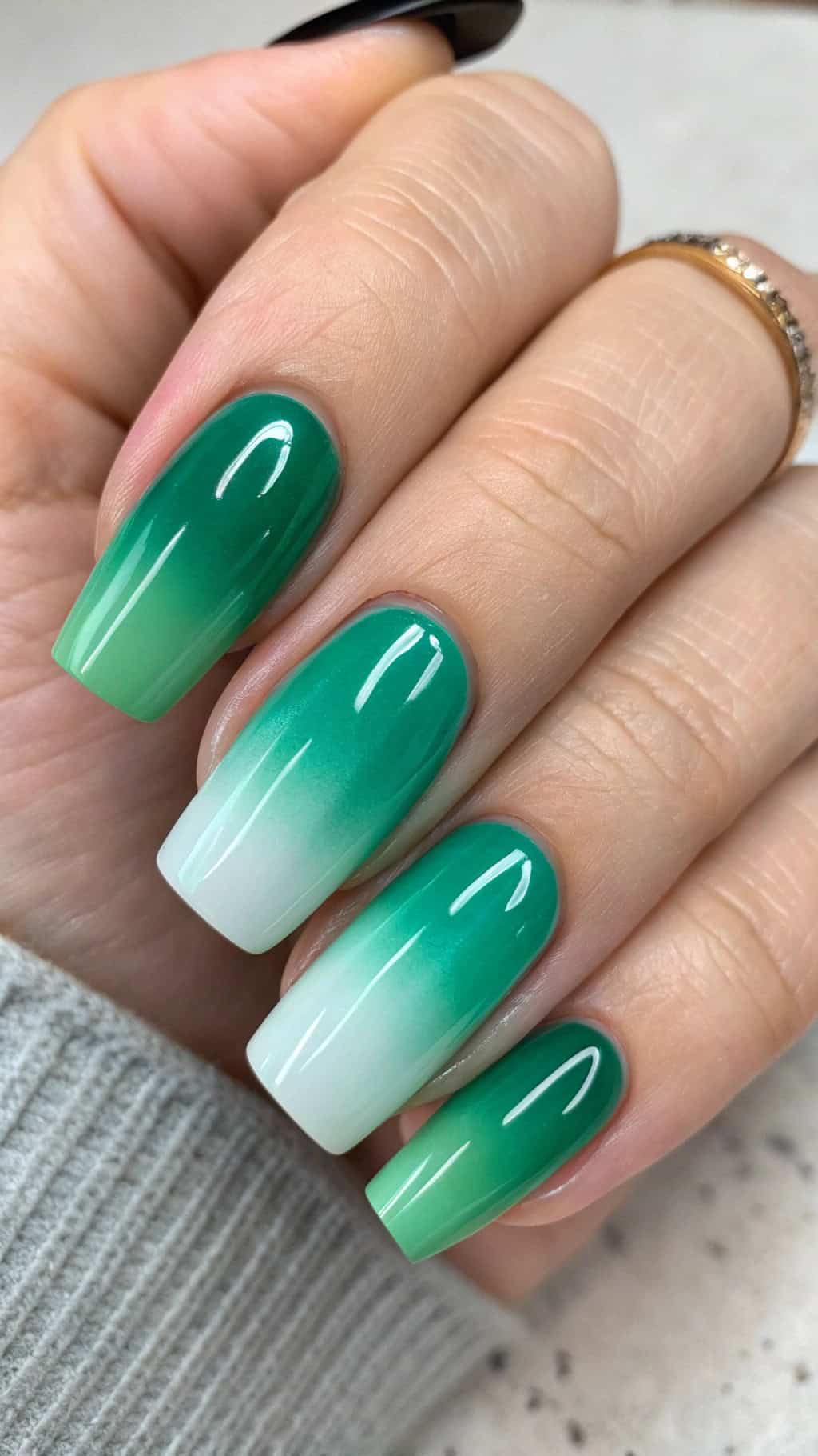 Emerald green ombre nails fading from deep emerald to soft sage