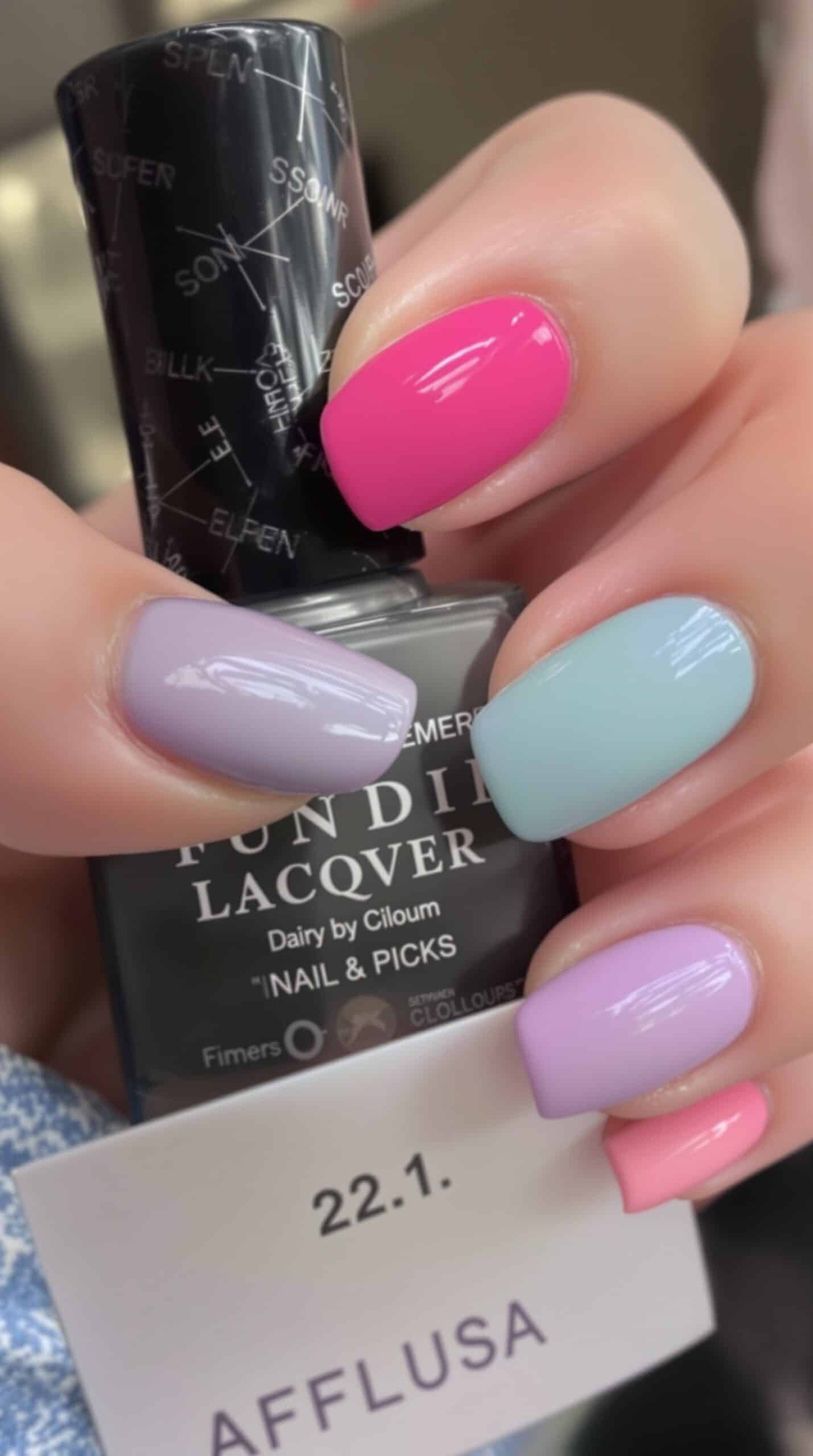 Bright pink and pastel lavender and blue nails with glossy finish.
