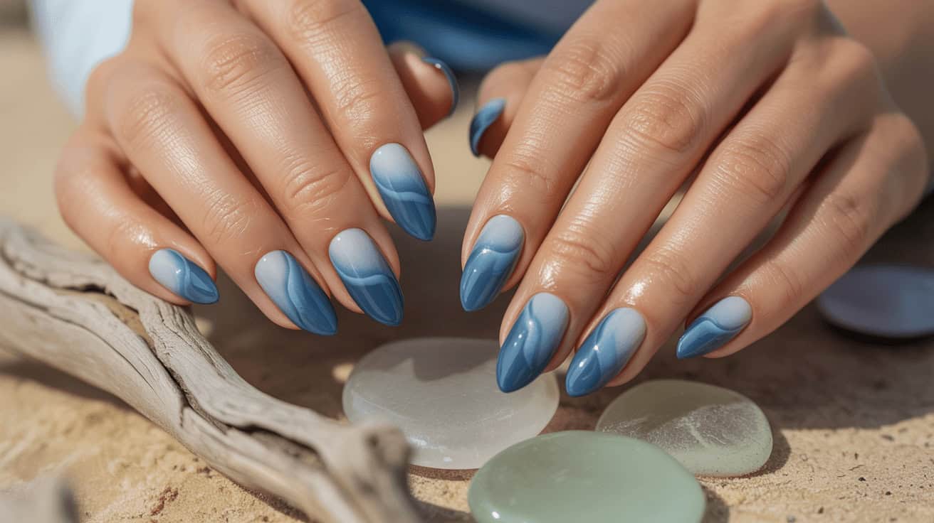 Summer nail colors 2026, beautiful blue marble nail design on well-manicured hands.